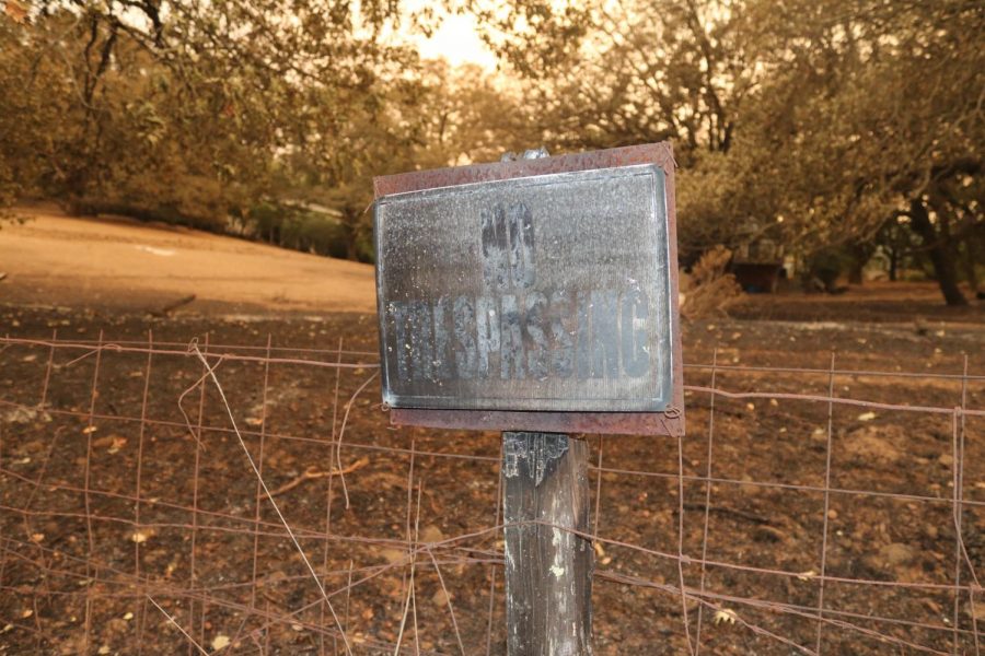 The charred remains of a "No Trespassing" sign near a home on Melita Rd.