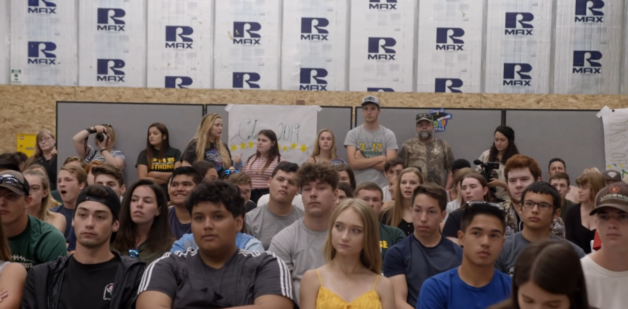 High schoolers sit in a makeshift auditorium after their high school's town was burnt down by the 2018 Camp Fire.
