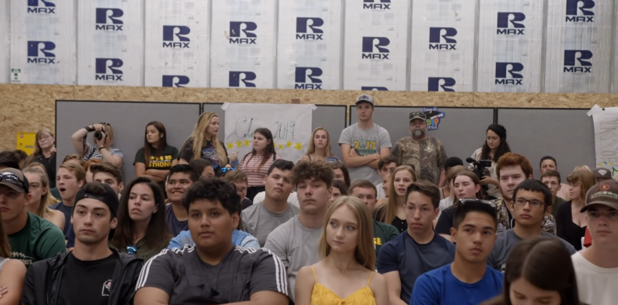 High schoolers sit in a makeshift auditorium after their high schools town was burnt down by the 2018 Camp Fire.