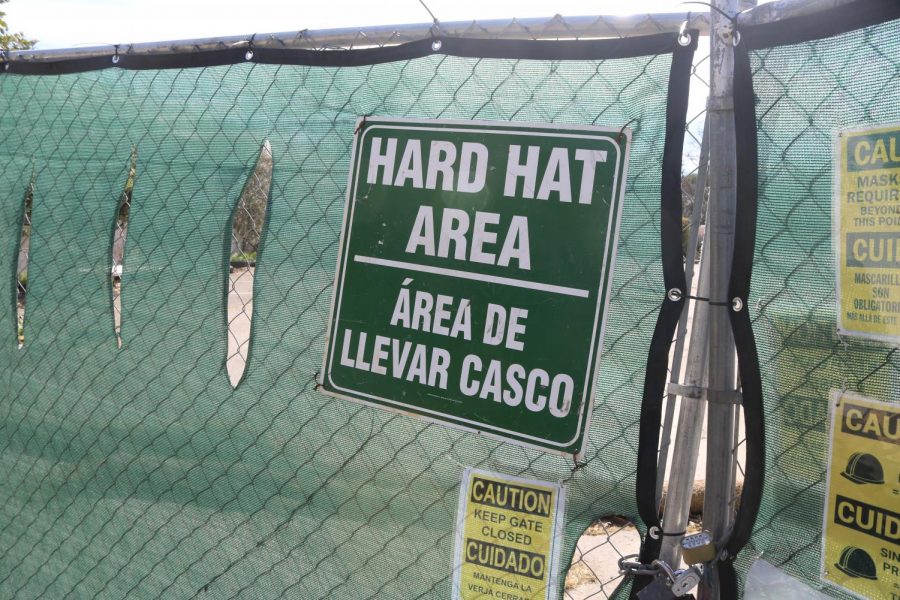 A sign reading "Hard hat area" adorns a fence surrounds the remains of the demolished Shuhaw Hall.