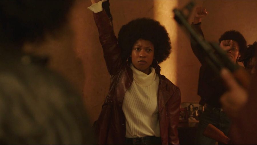 A young Black woman raises her fist in this screenshot from Ciani Rey Walker's "Misfits."