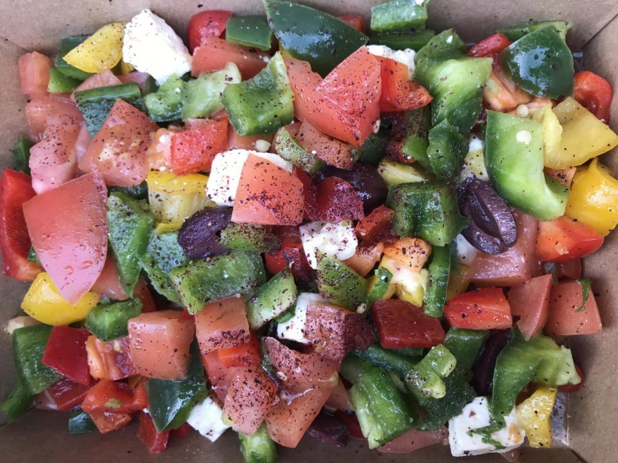 A serving of Greek Salad made from bell peppers, tomatoes, kalamata olives, feta, and cucumber from Zainas Bellini Cafe.