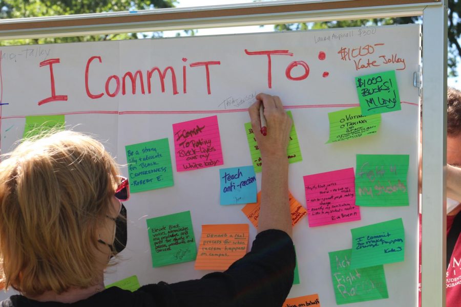 Participant writes a pledge amount to fund a Black student success center among other participants commitments to end systemic racism at SRJC.