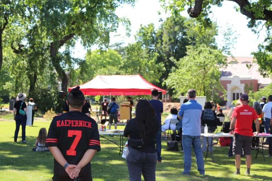 Protest participant listens to Summer Winston, faculty member and Blackout organizer, calling for action on campus. "I am not naive," Winston said. "My hope isn't to do the impossible of 100% curing the disease of racism on SRJC's campus. My hope is herd immunity. With enough of us deciding to shift our culture one commitment at a time, SRJC will shift."