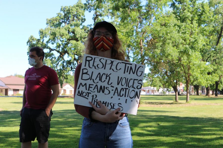 Student attendee holds a sign calling for action, a common theme of the protest.