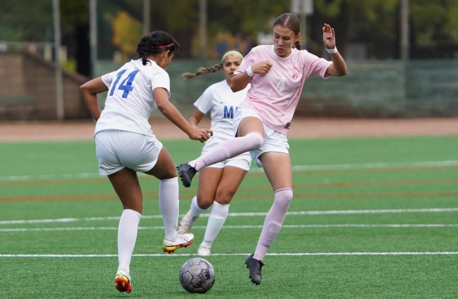 SRJC midfielder Abria Brooker (4) fights for possession with Modesto defenseman Mia Basi (14) during the second half of the Bear Cubs' 5-1 win over Modesto Oct. 22.