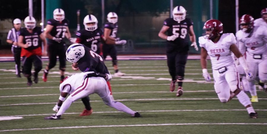 Quarterback Jake Simmons (3) trucks a Sierra defender as he lunges forward for a first down with his offensive line and wide receiver behind him on Nov. 13 at Bailey Field.