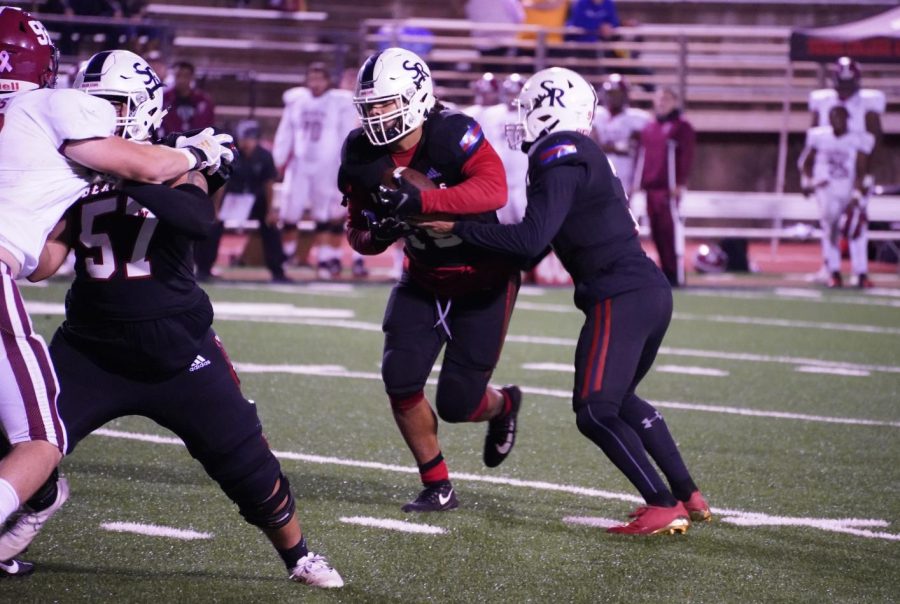 Quarterback Jake Simmons hands the ball of to Devonte Manning (15) on Nov. 13 at Bailey Field.