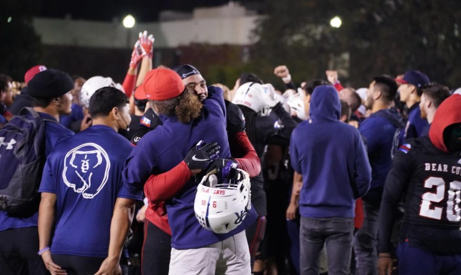 Head coach Lenny Wagner hugs Devonte Manning, who later received the game ball from Wagner on Nov. 13 at Bailey Field.
