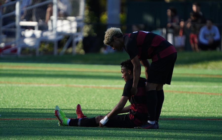 Santa Rosa freshman Gael Cervera (right) helps up distraught freshman teammate Billy Rodriguez (left) after the final whistle in a 1-0 loss vs. Consumes River on Nov. 23 at Sunrise Park in Rohnert Park. 