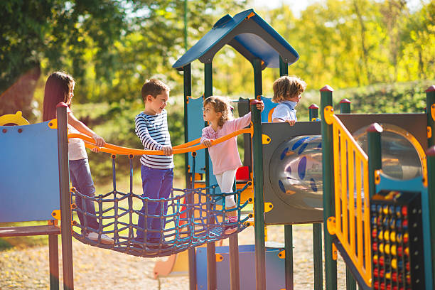 A group of children playing and socializing on a playground.