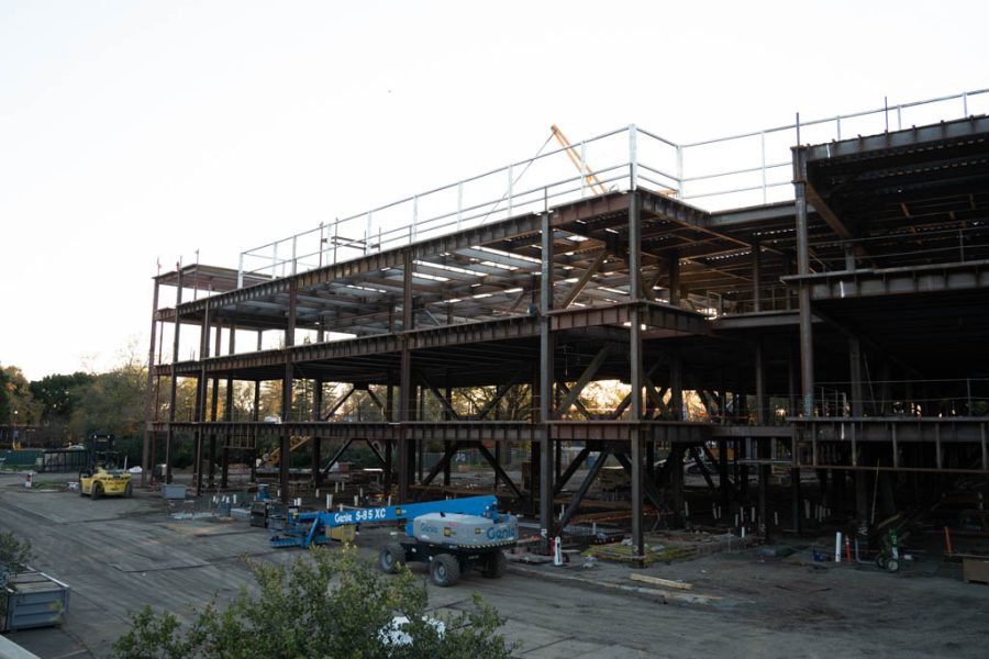 The frame of the new SRJC dorm building with a white sky nearing sunset in the background.