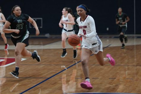 A SRJC women's basketball player dribbles the ball down the court.