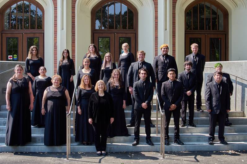 14 Santa Rosa Junior College choir and chamber singers and there instructor stand on the front steps of Burbank Auditorium in black formal wear.