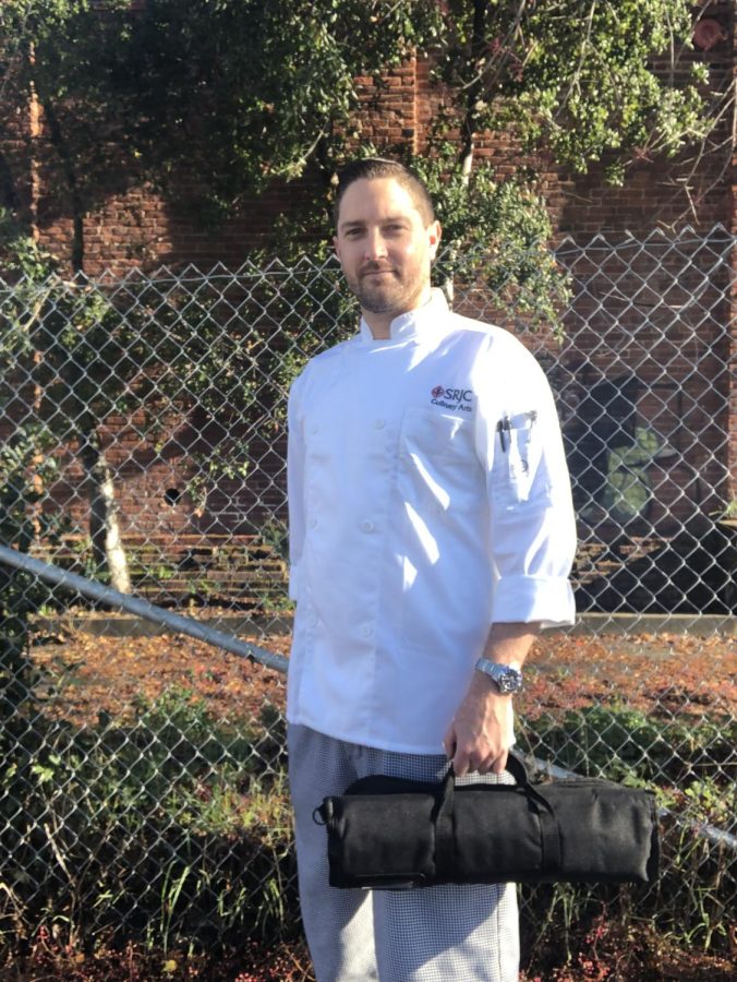 Michael Hogle, 39, poses in his Santa Rosa Junior College culinary arts jacket and holds a small tote bag
