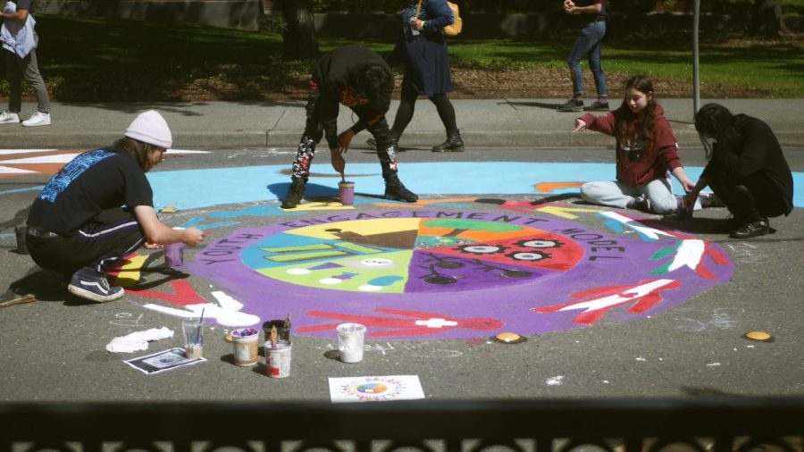 Painters finishing their design for their "Youth Engagement Model" mural created   on Earth Day