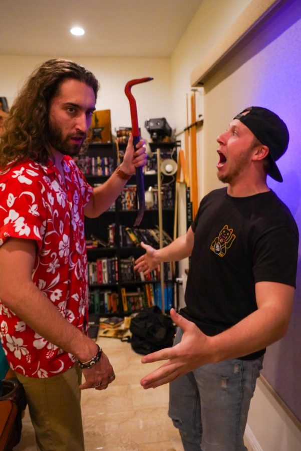 Actor Mahlon “Zach” Tracy (left) and Director of Photography Brandon Douglas (right) joke with each other during a walkthrough of a scene for “The Haunting Of Hype House” in Woodland Hills, Calif. on Feb. 3, 2022.