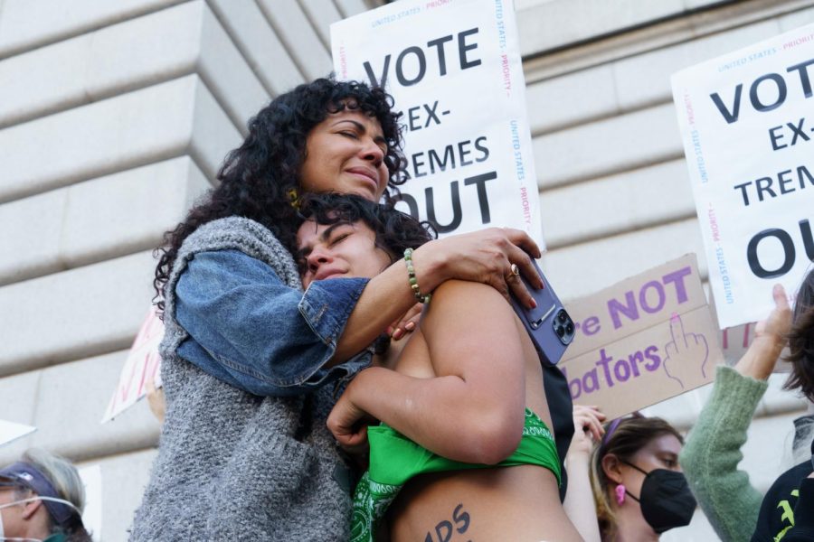 Maya Iribarren and Mitzi Rivas emotionally embrace for a moment after intense chanting during a protest against the overturning of Roe v. Wade on June 24, 2022, in San Francisco.