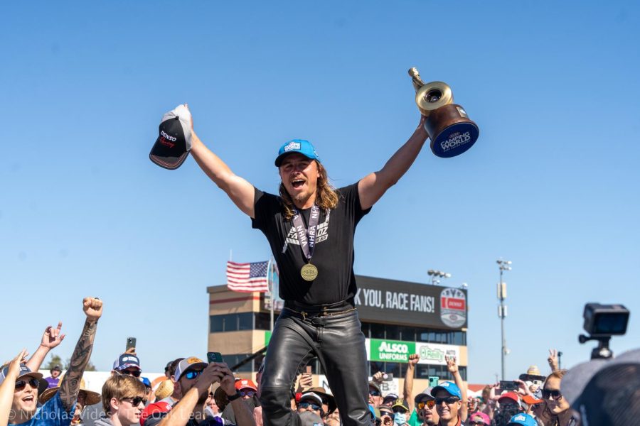 Joey Gladstone roars onto the victory stage with his trophies after winning the Pro Stock Motorcycle Finals at the Denso NHRA Sonoma Nationals on Sunday July 24, 2022.