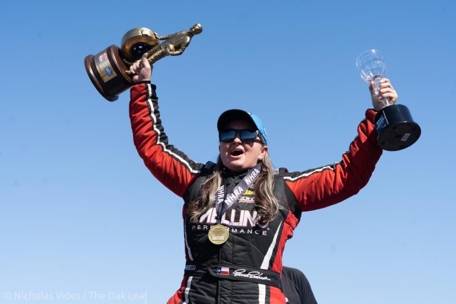 Pro Stock driver Erica Enders exclaims joy as she hoists her victory trophy at the Denso NHRA Sonoma Nationals on Sunday July 24, 2022. 