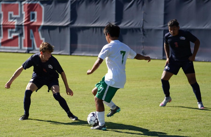 Bear Cubs midfielder Sam Nolan (6) and defender Angel Barajas (3) defend against Cañada College forward Kiichi Murakami in a 2-1 win Sept. 13.