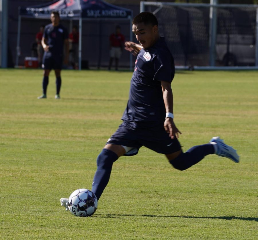 Bear Cubs midfielder Alan Sanchez strikes the ball towards the opposite side of the pitch in a 2-1 win over Cañada College Sept. 13.