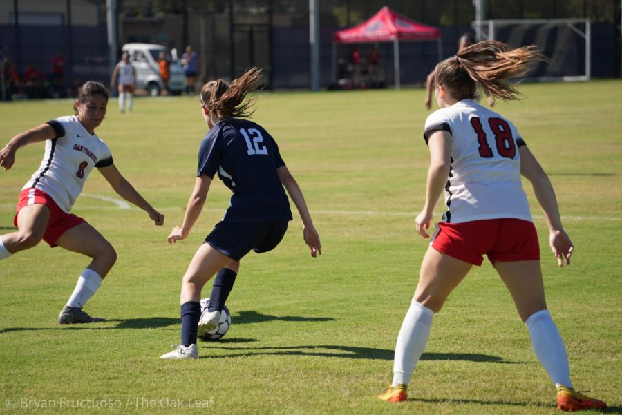 Bear Cubs Forward Olivia Parlato (#12) battles for ball control against San Francisco Community College players in Santa Rosa on Aug. 30, 2022.