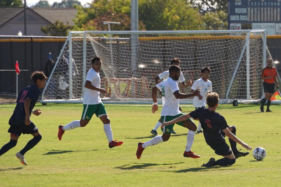 Bear Cubs midfielder Sam Nolan (6) makes a slide tackle against several Cañada College forwards in a 2-1 win Sept. 13.