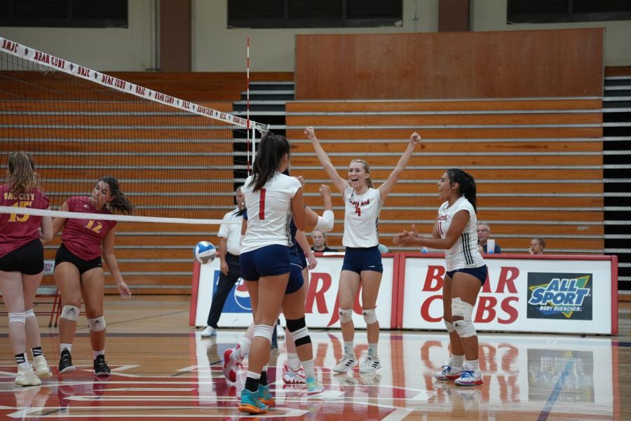 Bear Cubs celebrate after scoring another point off a block in the fourth set.