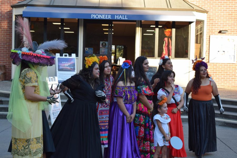 A group of SRJC students and members of the community showcase their traditional attire, some even dress as catrinas, an elegantly dressed skeleton. 