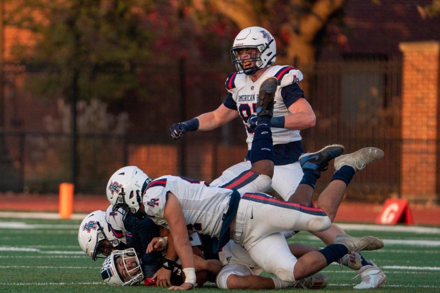 Santa Rosa Junior College quarterback Santino Chavez, bottom, gets wrapped up by American River College defenders on Saturday, Oct. 29, 2022 in Santa Rosa.