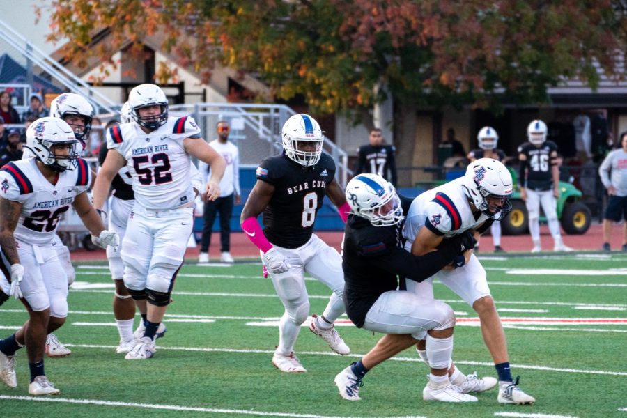 Santa Rosa Junior College defensive end Max Gonzalez sheds a block and wrestles down American River quarterback Kenneth Lueth for a sack on Saturday, Oct. 29, 2022 in Santa Rosa.
