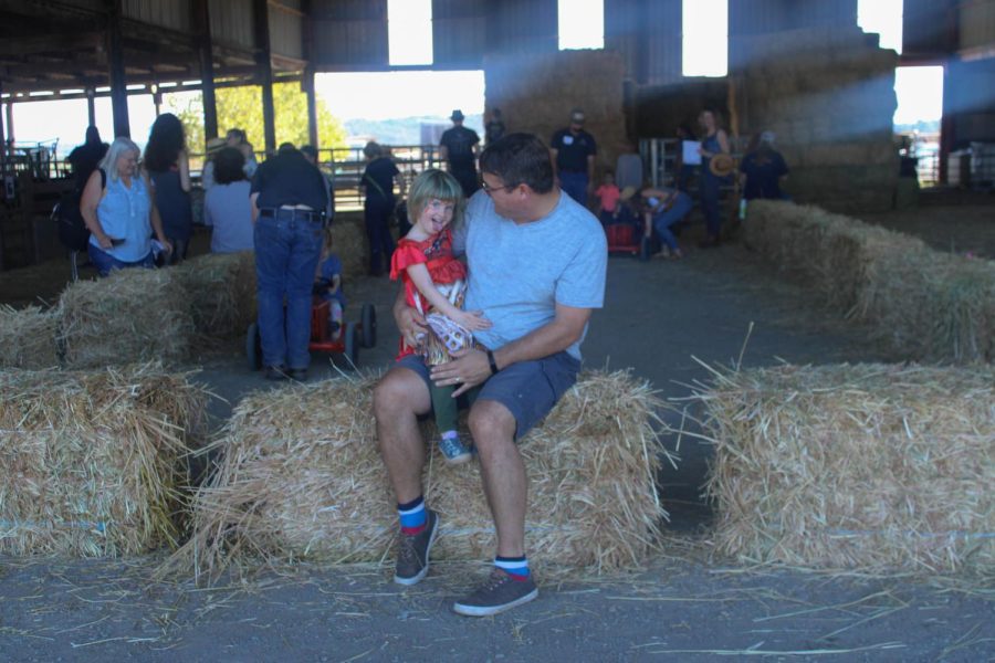 Teun Oome and his daughter Celine enjoy the barn area, where tractor bikes and hay bails were available for children to play with. 
