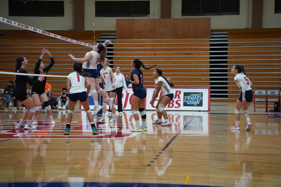 Bear Cubs Middle Blocker Aleah Molina returns the ball by going high spike in the second.