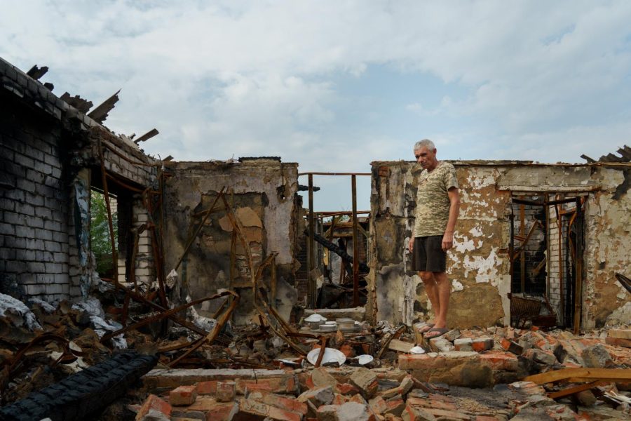 Ukrainian Hennadyi Balabonav walks among the burnt remains of his home, burned down by Russian forces in revenge for his son's military service, in Malaya Rohan on Aug. 10. 2022.
