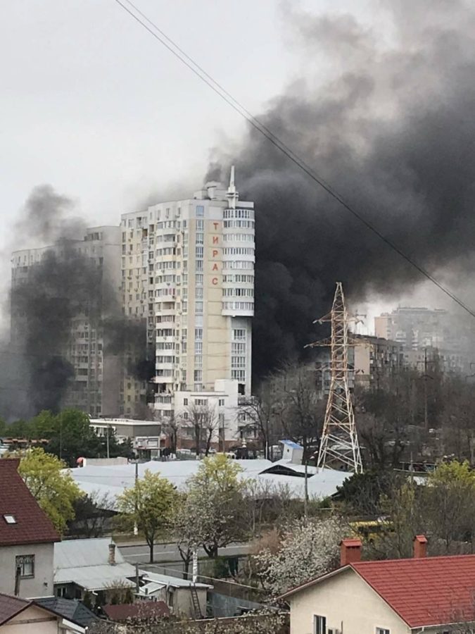 A photo sent to Yana Kalmykova shows a high-rise building burning moments after a Russian artillery strike that Yana was hiding from one block away in her mother's basement