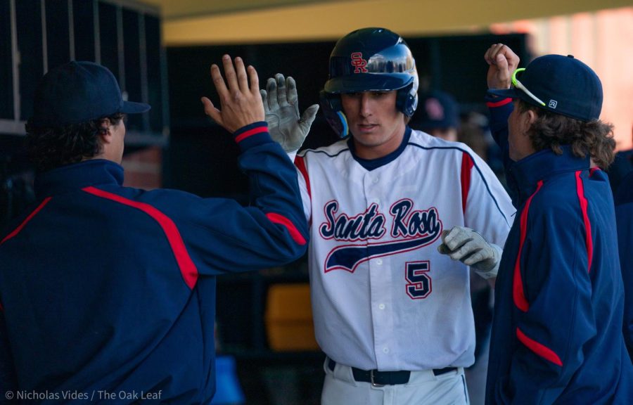Bear Cubs designated hitter/pitcher Austin Ehrlicher is high-fived by his teammates after having a 4-6, 4 RBI night against College of Marin on Tuesday, Feb. 21, 2023 in Santa Rosa.