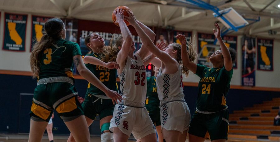 Forwards Meredith Gilbertson and Rose Nevin fight for a rebound among a sea of Napa Valley defenders against Napa Valley on Saturday, Feb. 25 in Santa Rosa.
