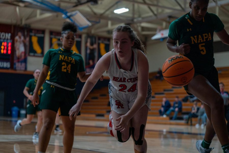 Forward Rose Nevin loses control of the ball and dives out of bounds against Napa Valley on Saturday, Feb. 25 in Santa Rosa.
