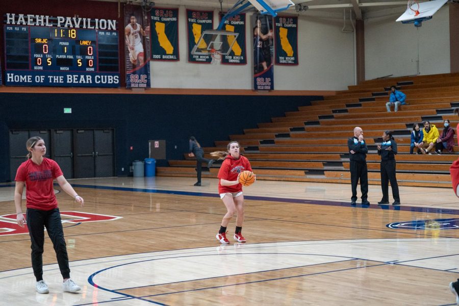 Guard Lucca Lowenburg takes a 3-pointer in warmups before the game against Laney College Saturday, March 4. 
