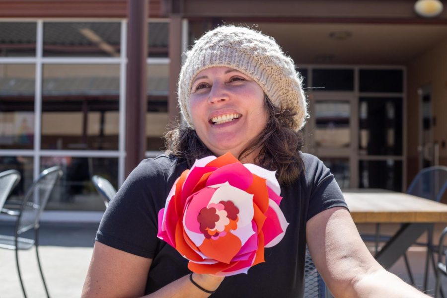 Caridad Celicia smiles with a flower she made. 