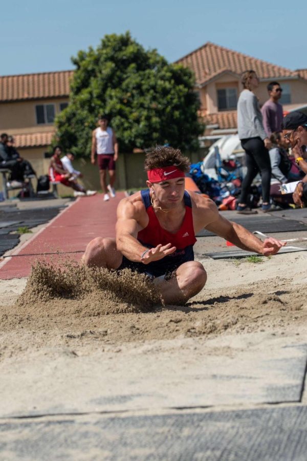 Luis braces for impact as he lands during his Long Jump event.