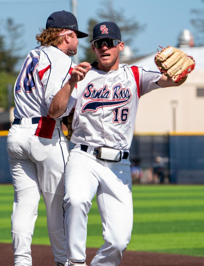 Bear Cubs outfielder Jake McCoy, right,  leaps into second baseman Joe Brown after throwing out a Cañada College runner at third base from deep right field on Thursday, May 11, 2023 in Santa Rosa.