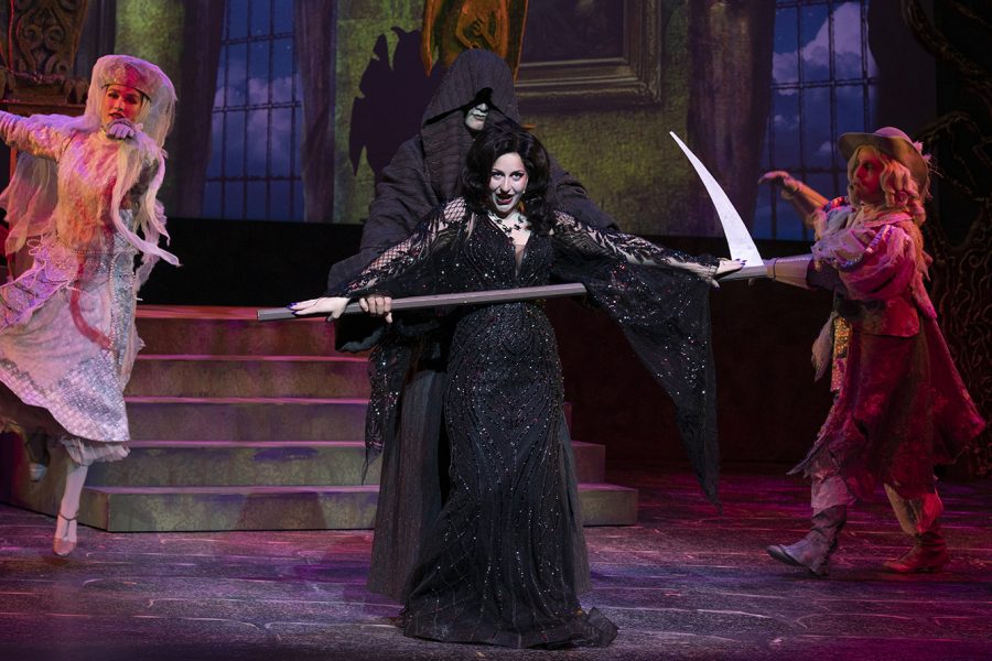 The Addams Familys signature dark humor is put on full display as Morticia Addams, played by Gwenevieve Nelson, gleefully sings a lighthearted song about death being Just Around the Corner.