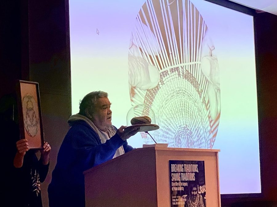 Dan Aguilar holds up a basket made by Elsie Allen, who decided to break the tradition of burying or burning baskets when a community member died so she could use them to raise awareness about Pomo culture. 
