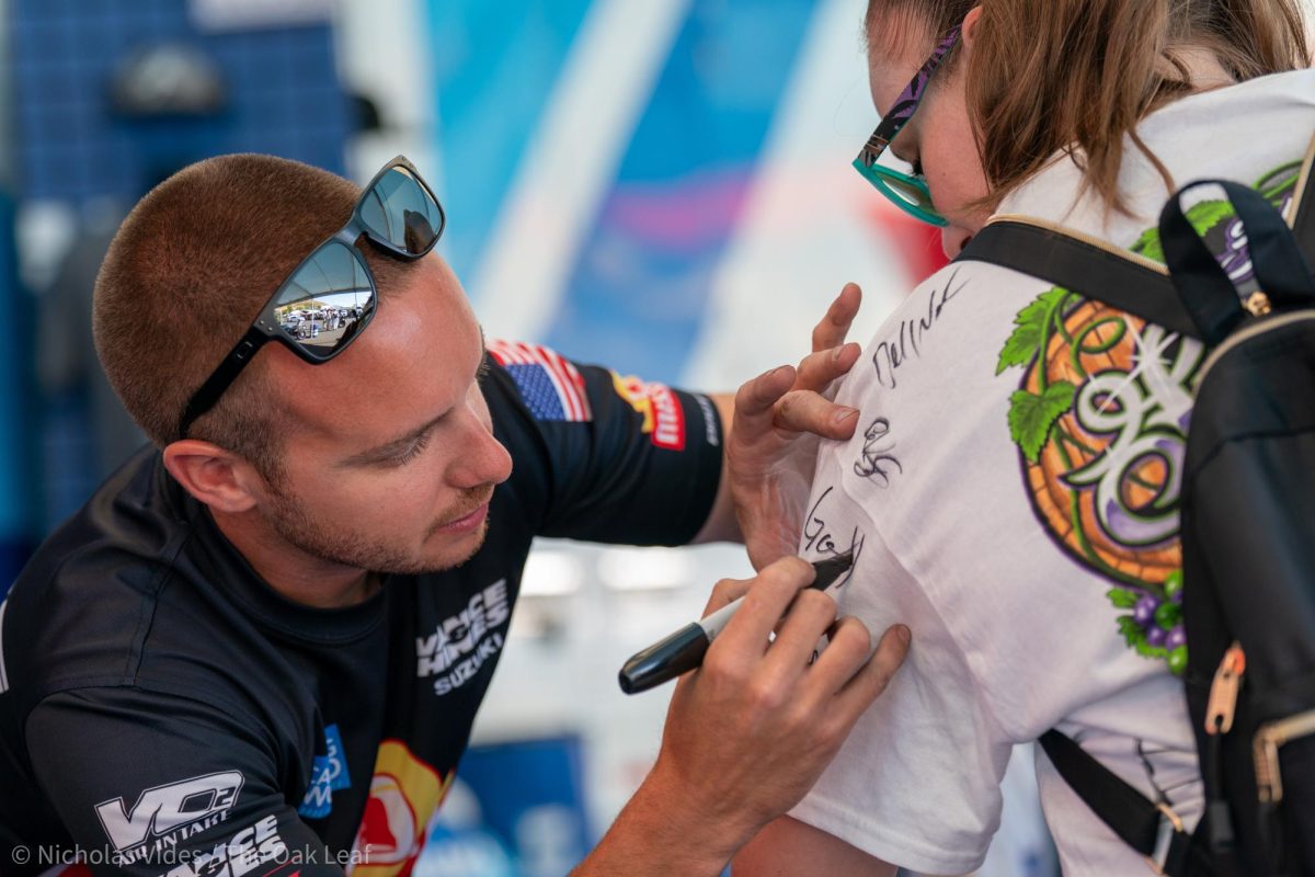 Pro Stock Motorcycle driver Gaige Herrera signs a fans T-shirt at the DENSO NHRA Sonoma Nationals on Saturday, July 29, 2023.