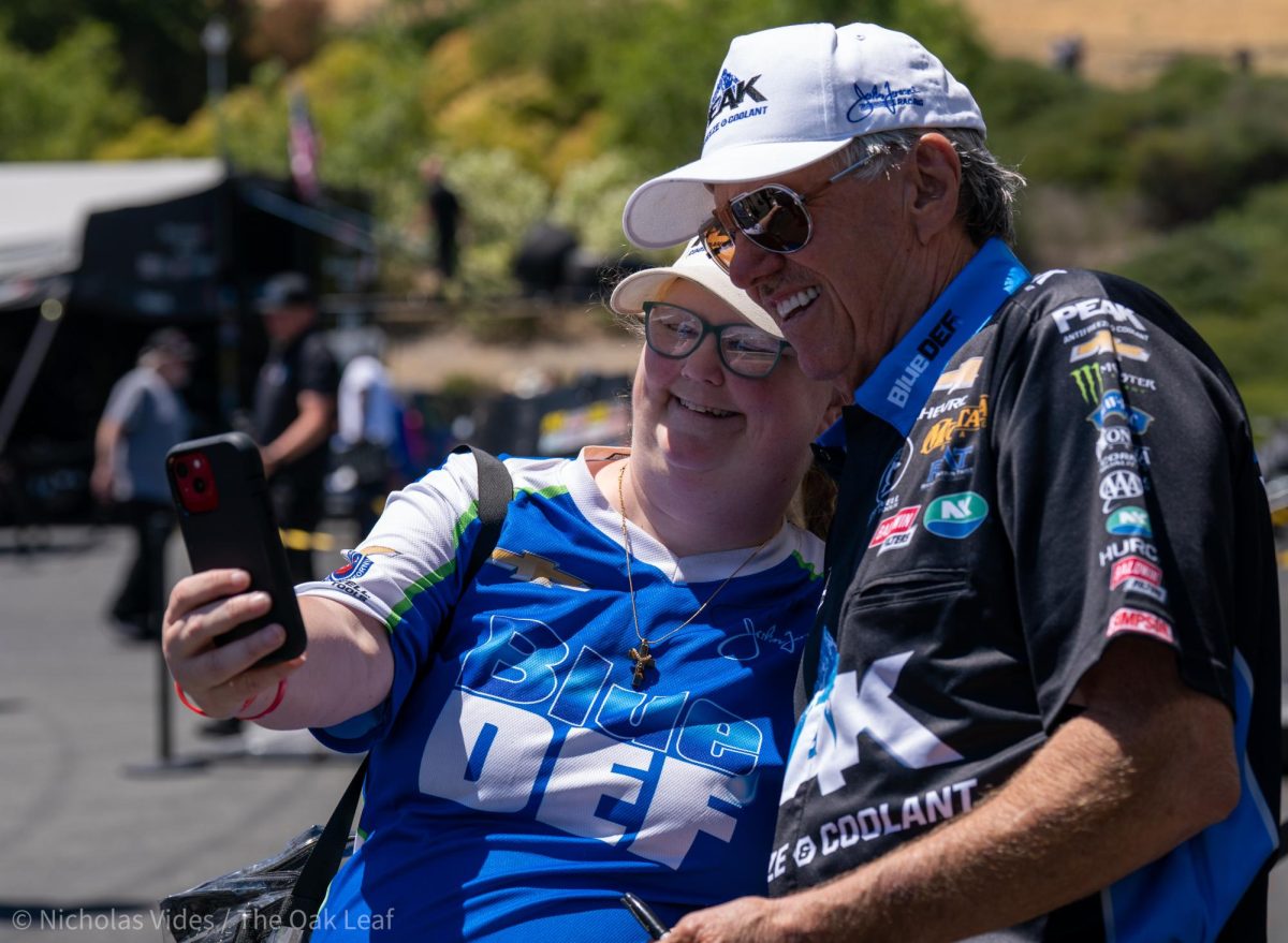 Funny Car Driver John Force signs and takes photos with fans at Sonoma Raceway on Friday, July 28, 2023 in Sonoma. (Nicholas Vides / The Oak Leaf)