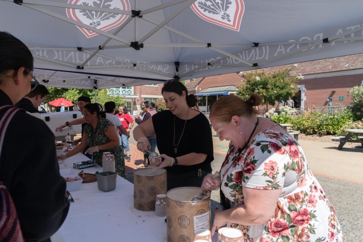 Mary Katherine Oxford scoops ice cream for students at the Ice Cream Social, hoping to get new students more comfortable on SRJC's Santa Rosa campus. "My arm is sore. I've scooped so much!" she said.