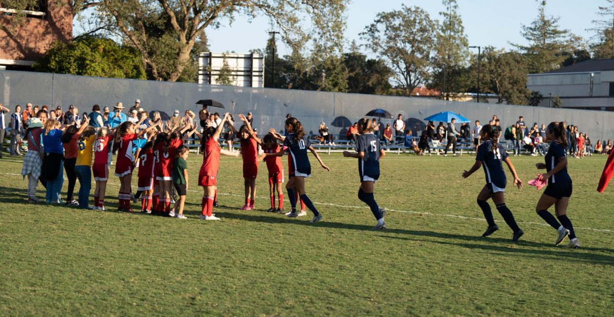 Children from a local soccer team create a tunnel for the Bear Cubs to run through following their victory Tuesday, Oct. 24 against Diablo Valley. Throughout the game, the children cheered the team on, garnering affectionate awwws from both spectators and players.