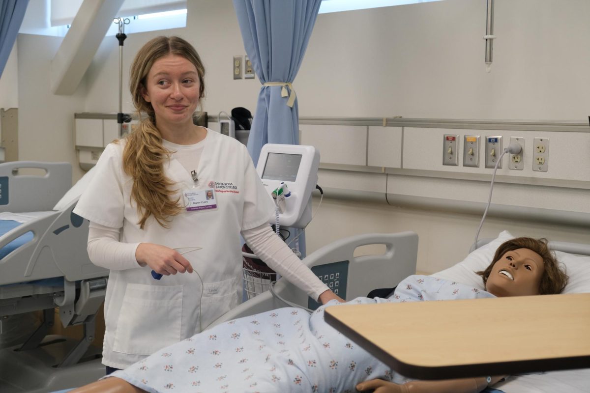SRJC nursing student Meghan O'Leary practices her bedside manner with a manikin.  